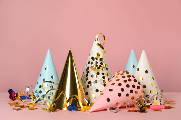 Colorful party hats and festive items on pink background - Φωτογραφία, εικόνα