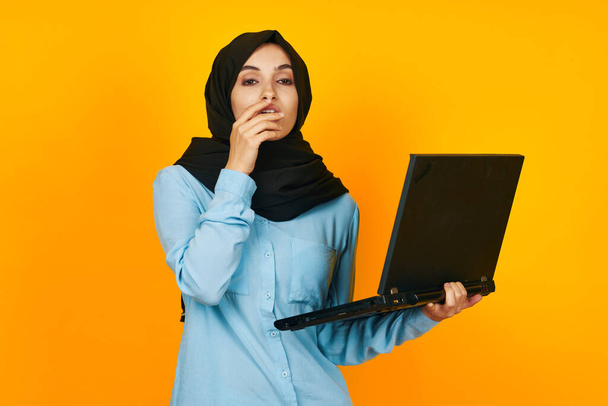 arab woman with laptop in hands technology emotions isolated background - Foto, imagen