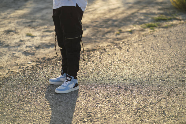 The lower half of a male in a cool street style outfit with sneakers - Photo, Image