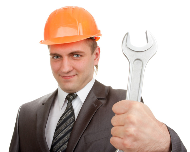 Engenheiro sorridente em chapéu duro com chave
 - Foto, Imagem
