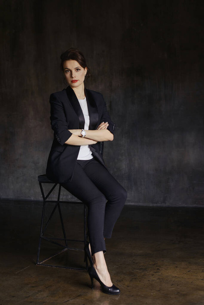 Stylish young girls in pantsuits pose in a photo studio. - Foto, Imagem