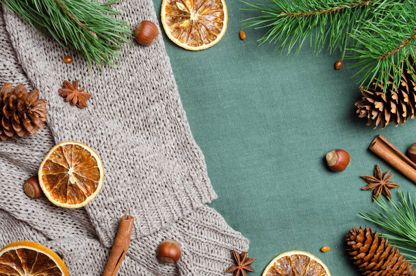 Christmas flat lay with spices and pine tree branches with cones on knitted background - Fotografie, Obrázek