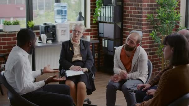 Multi ethnic people having discussion about addiction at aa group therapy - Footage, Video