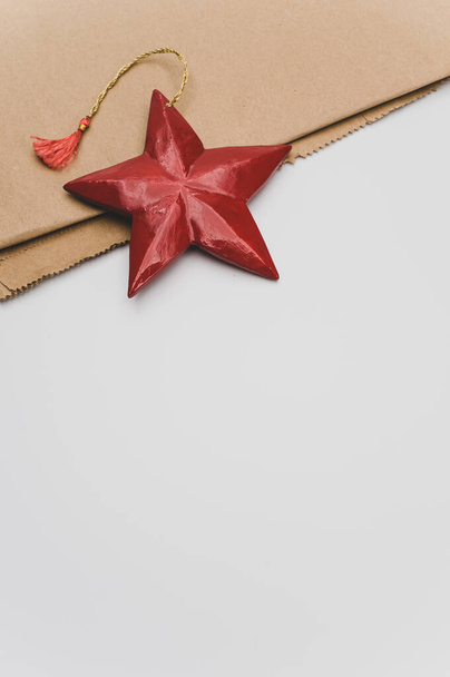 red painted decorative wooden star on a white background with copy space - Foto, imagen