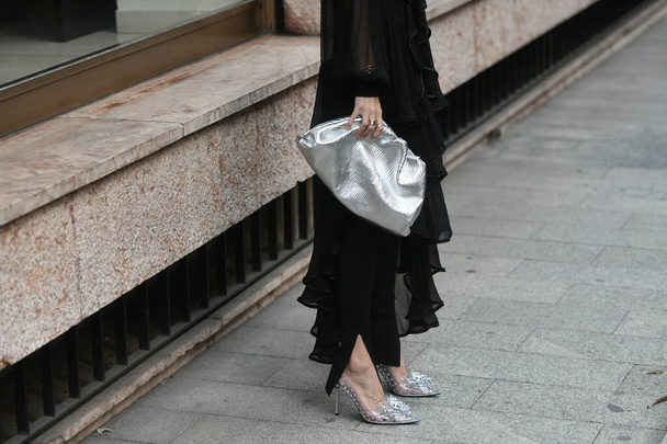 Milan, Italy - September 22, 2021:  Street style outfit, fashionable woman wearinga black outfit, skinny leggins pants, pointed pumps heels with a knot on the toe-cap on the streets of Milan, Italy. - Foto, Imagem