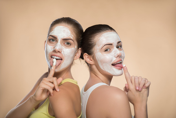 Girls applying facial cream mask - Foto, Imagem