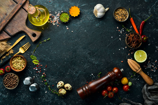 Black stone background with vegetables and spices.Top view. Rustic style. - Foto, Imagen