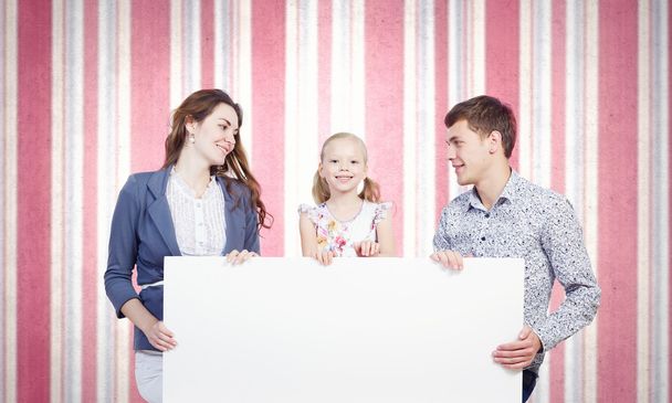 Family with white blank banner - Foto, imagen