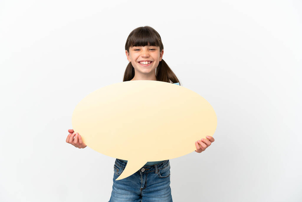 Little caucasian kid isolated on white background holding an empty speech bubble - Fotó, kép