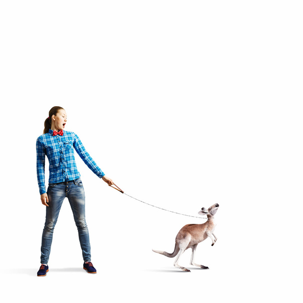 Woman holding kangaroo on lead - Foto, immagini