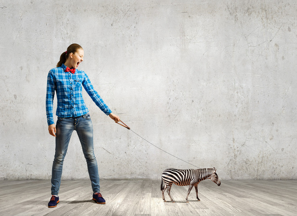 Woman holding zebra on lead - Foto, Imagen