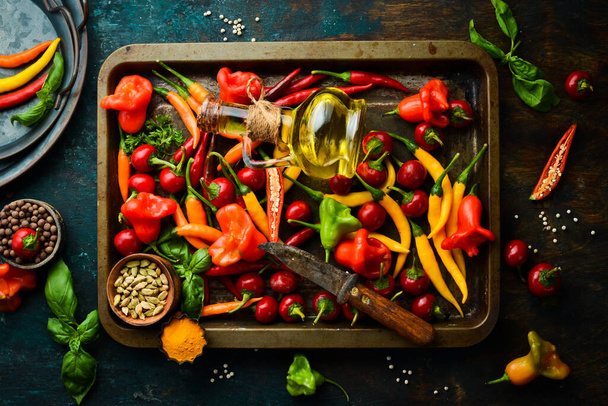 Fresh hot pepper on a metal tray. Food background. Top view. - 写真・画像