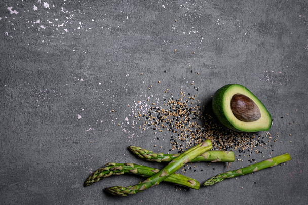 gray food background asparagus avocado sesame - Fotó, kép
