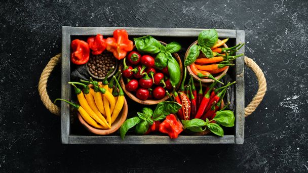 Spices in a wooden box: basil, pepper, oil, paprika, herbs. Food background. Top view. - Φωτογραφία, εικόνα