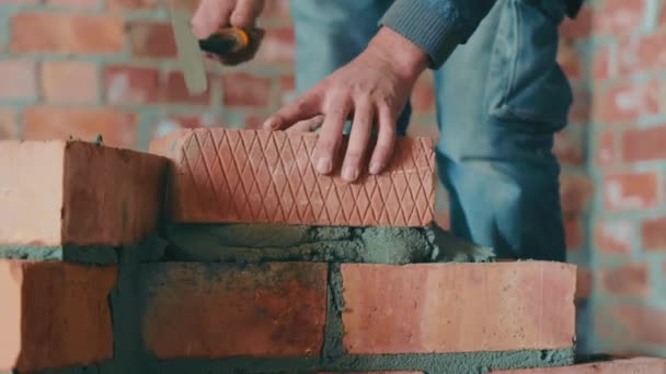 Masters lay bricks and build the wall of the house. Construction work on construction. Construction of interior partitions from red brick. - Footage, Video