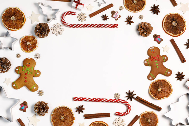 Christmas food frame isolated on white background dry orange gingerbread cookies candy canes - Фото, зображення