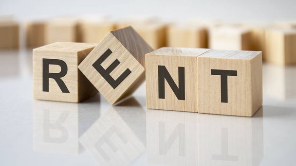 rent text on wooden blocks. the concept of renting housing. rental. saving money. - Photo, Image