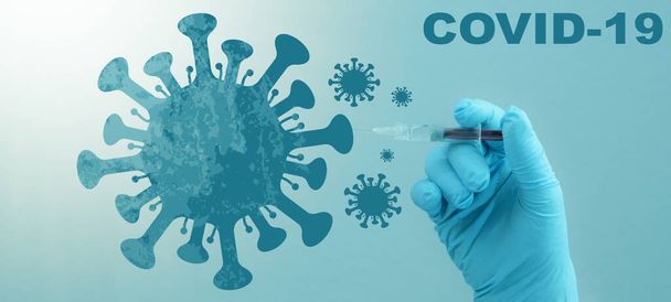CORONAVIRUS - CORONA VACCINATION STOP COVID-19 - Doctor with syringe in hand injects Corona vaccine into a virus symbol, isolated on blue background - Foto, immagini