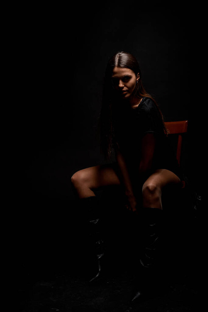 Studio body shot of a trendy young woman wearing elegant black clothing - Fotografie, Obrázek