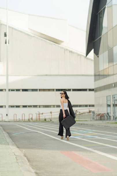 Beautiful businesswoman is walking fast towards her company - Zdjęcie, obraz