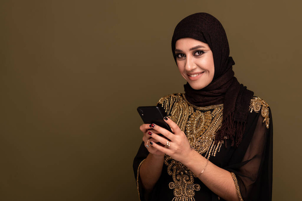 Portrait of beautiful young muslim arabian woman wearing hijab looking at camera, copy space - 写真・画像