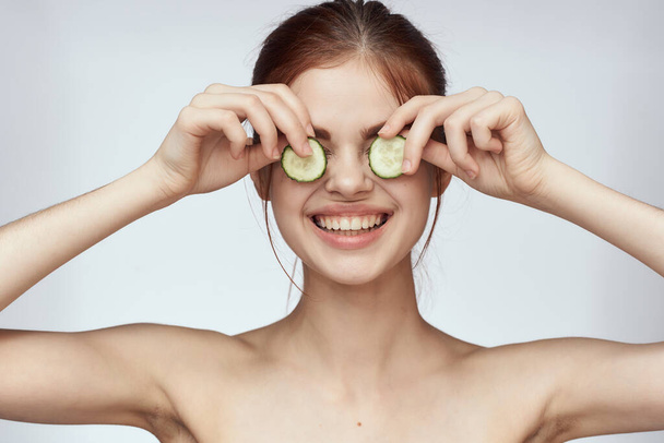 cheerful woman with cucumbers in hands cosmetology vitamins health - Foto, Imagen