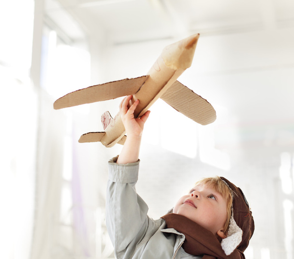 Happy boy with airplane in hand - Zdjęcie, obraz