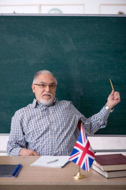 Old english language teacher in the classroom - Photo, Image
