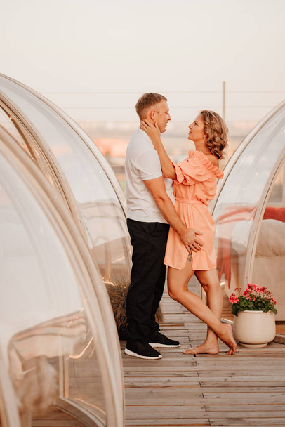beautiful man and woman in love in original place for dating on rooftop - Foto, Imagem