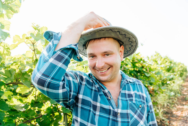 handsome caucasian farmer man looks at the camera and smiles handsome, - Foto, Imagem