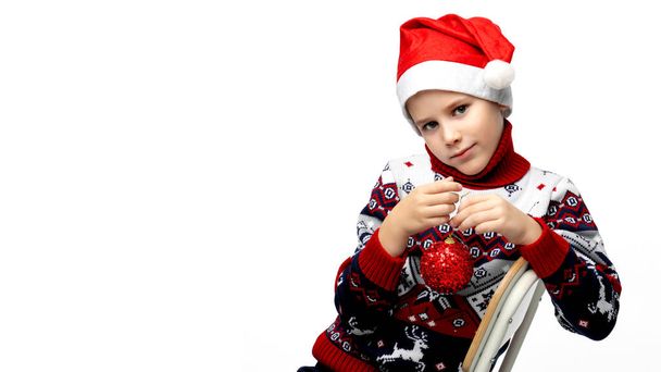 A boy in a Santa Claus hat for Christmas - Фото, изображение