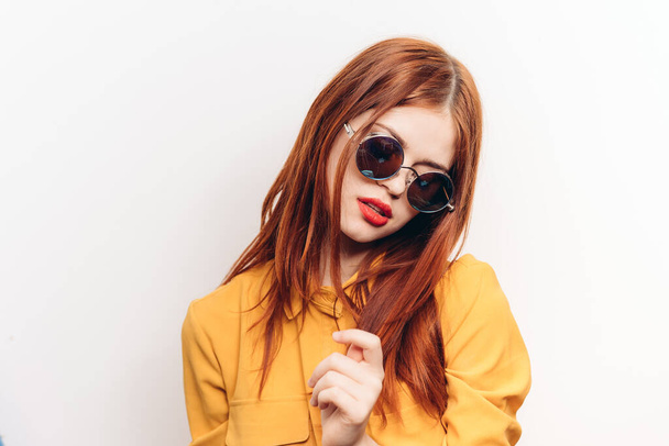 attractive woman hairstyle glamor sunglasses glamor light background - 写真・画像