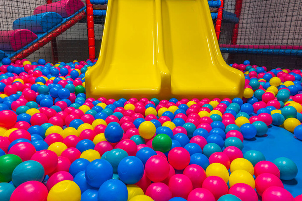 Beautiful view of playing in pool with plastic balls and slide on indoor playground in activity center. Sweden. - Fotografie, Obrázek