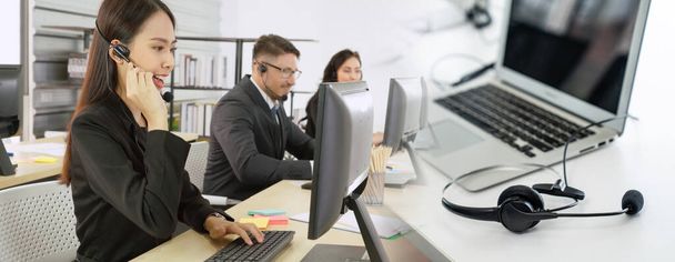 Business people wearing headset working in office broaden view - 写真・画像
