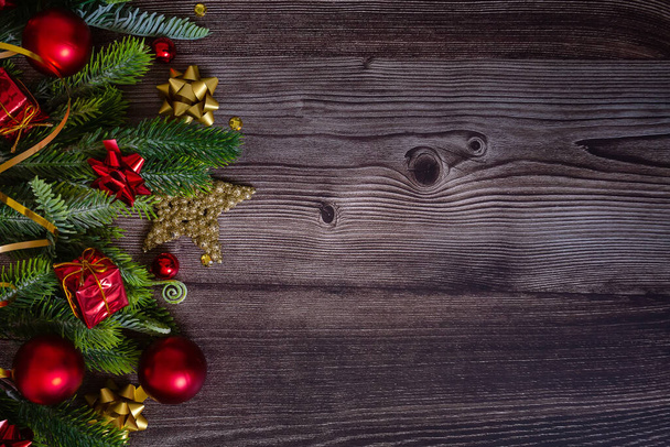 Різдвяний фон з ялиновими гілками, червоними і золотими прикрасами і сосновими шишками на сільському дерев'яному столі. Пласка лежала. вид зверху з простором для копіювання
 - Фото, зображення