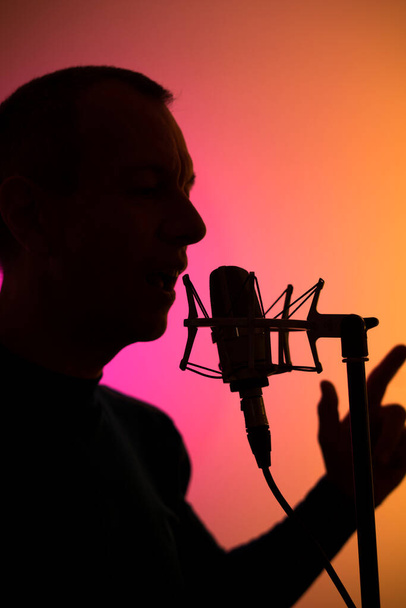 Голосовий актор у вокальній студії з великим діафрагмовим мікрофоном та антипоп-щитом
. - Фото, зображення