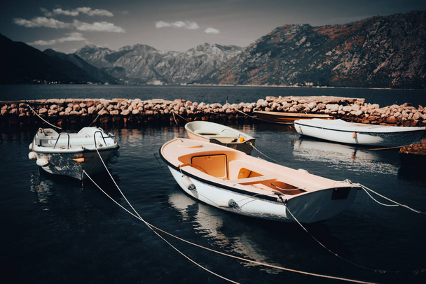 Dark atmospheric picture of nature. Montenegro mountains, boats in the water. Weather before rain, stylish postcard. - Fotoğraf, Görsel