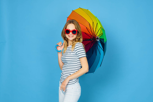 pretty woman fashion posing colorful umbrella blue background - Foto, Imagen
