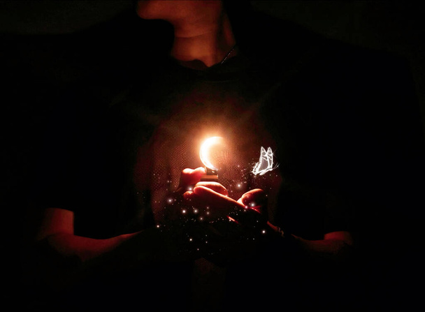man with a burning candle in the hands of a woman - Fotografie, Obrázek