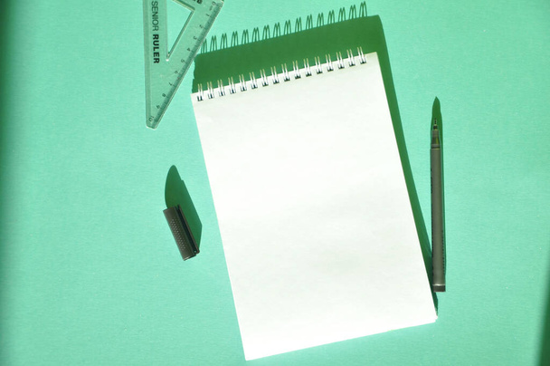 Notepad, pencil, ruler on a bright blue background - Photo, image