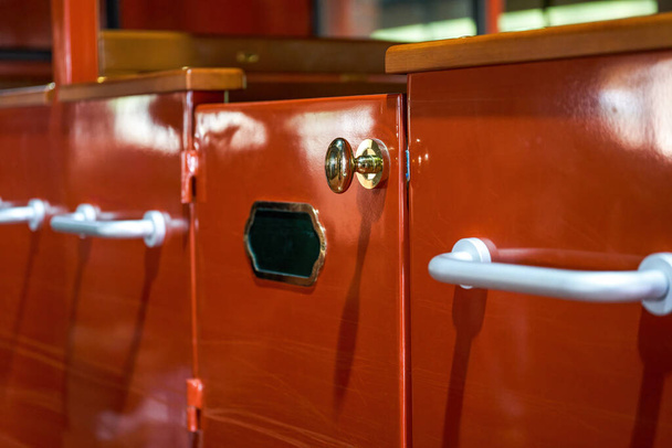 Close-up of partial red doors and golden handles of retro train carriages - Photo, Image