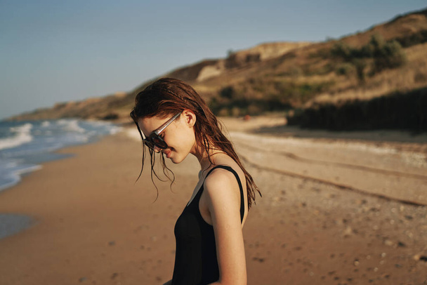 pretty woman in black swimsuit beach nature sun - Valokuva, kuva