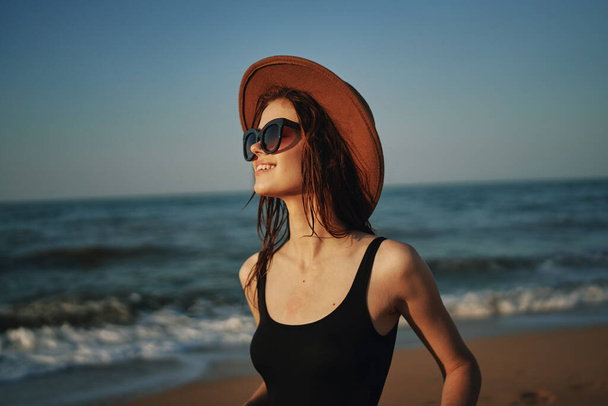 pretty woman in hat walking on the beach ocean travel - 写真・画像