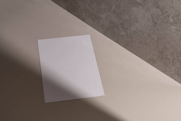 A close up of a white mockup blank on a new Stucco wall with a shadow and sunlight, ceramic floor - Фото, зображення