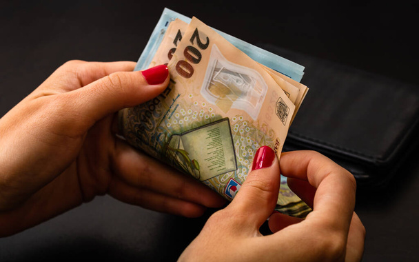 A closeup shot of a woman's hands counting money - Foto, Imagem