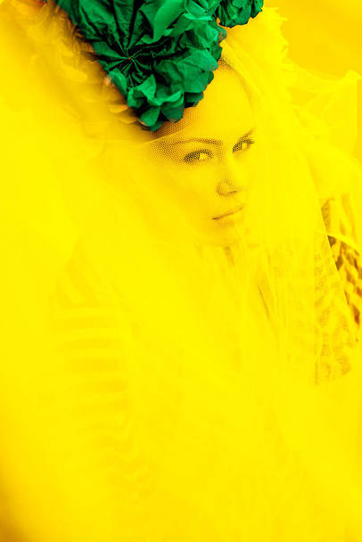 large portrait of a girl through a veil in yellow - Foto, immagini