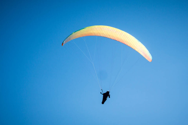 paragliding flight in the mountains. Le Grand-Bornand, Haute-Savoie, France - 写真・画像