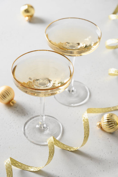 Festive New Year champagne and Christmas gold baubles on white background. - Valokuva, kuva