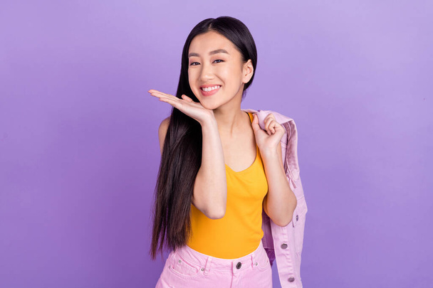 Photo of cute millennial brunette lady wear orange top isolated on violet color background. - 写真・画像