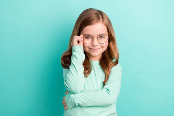Photo of young attractive girl happy positive smile hand touch eyeglasses isolated over teal color background. - Фото, зображення
